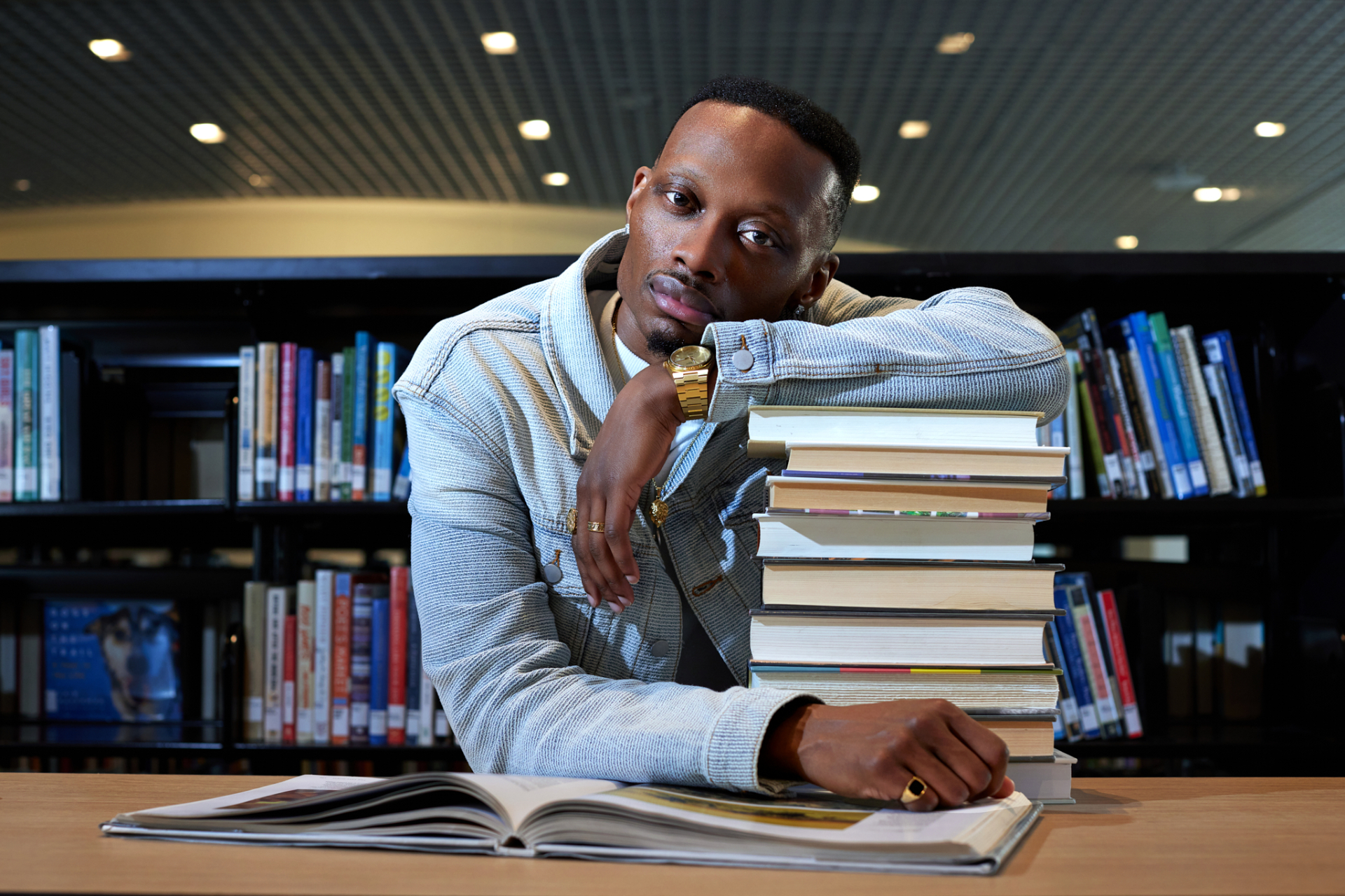 Bobby McNeil Jr. in the library with a stack of books